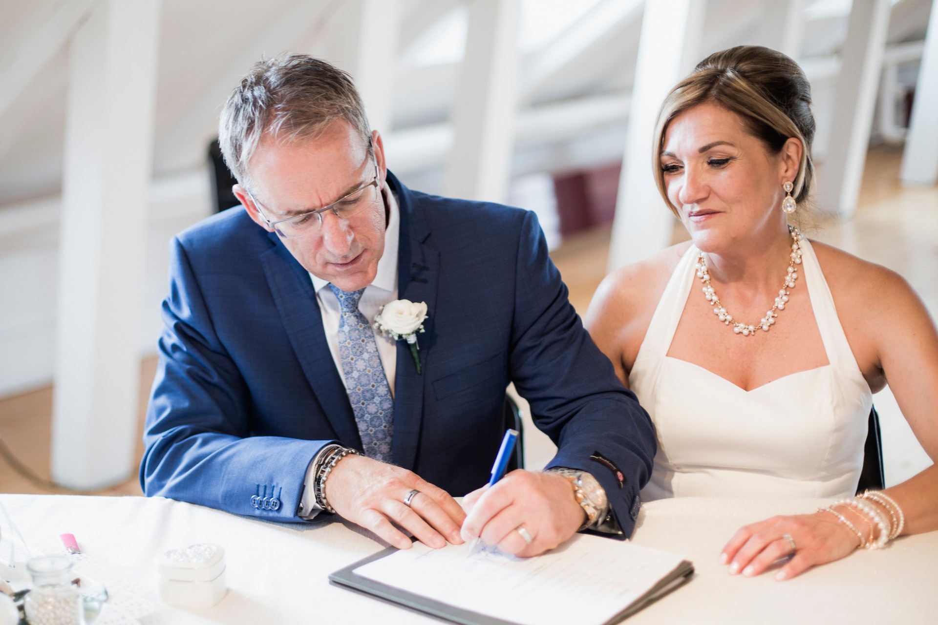 Groom and bride signing wedding papers